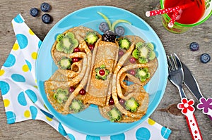 Funny Butterfly face pancakes with berries and fruits for kids`