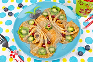 Funny Butterfly face pancakes with berries and fruits for kids`