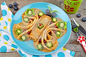 Funny Butterfly face pancakes with berries and fruits for kids`