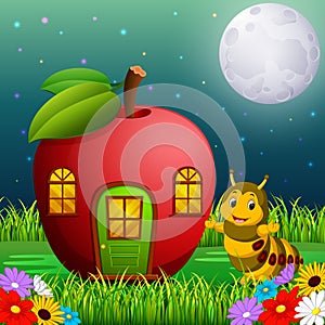 Funny caterpillar and a apple house in forest photo