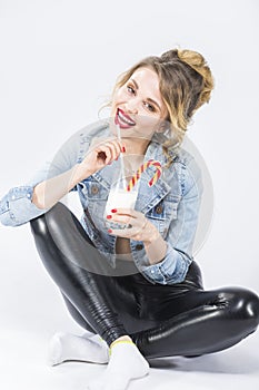 Funny Caucasian Blond Girl Drinking Milkshake Through Straw in Glass.