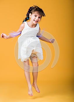 Funny cheerful beautiful girl bounces in studio photo
