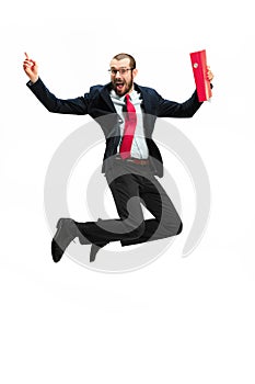 Funny cheerful businessman jumping in air over white background