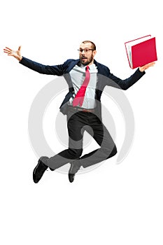 Funny cheerful businessman jumping in air over white background