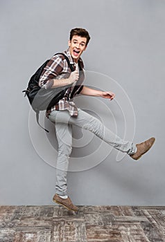 Funny cheerful male student jumping