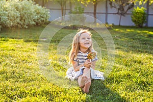 Funny child with candy lollipop, happy little girl eating big sugar candy.