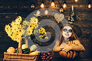 Funny child dressed witch costume. Cheerful child with pumpkins and candy. Happy Halloween Cute girl child making funny