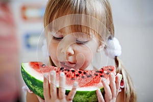 Funny child eating watermelon