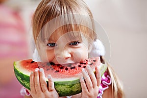 Funny child eating watermelon