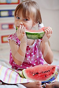 Funny child eating watermelon