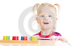 Funny child in eyeglases playing logical game photo