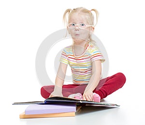 Funny child in eyeglases reading book isolated photo