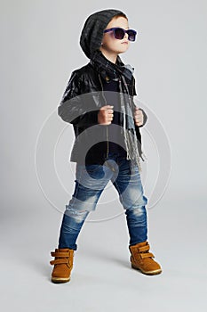 Funny child.fashionable little boy in sunglasses.stylish kid in yellow shoes