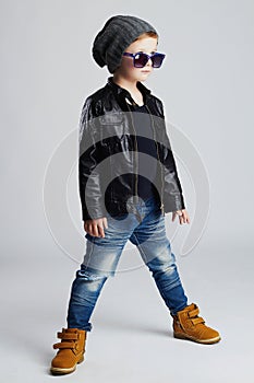 Funny child.fashionable little boy in sunglasses.stylish kid in yellow shoes