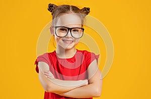 Funny child girl in glasses on colored background photo