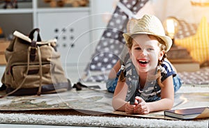 Funny child girl tourist with world map, backpack and magnifier