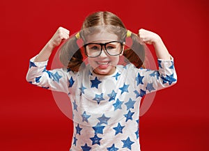 Funny child girl in glasses on colored background