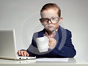 Funny child in glasses. little boss in office