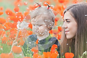 Funny child holding a balloon outdoor at poppy field