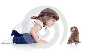 Funny child and kitten sitting on floor