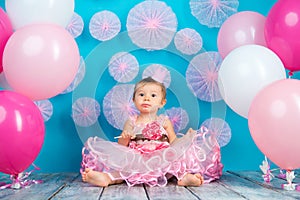 Funny child with a lollipop in the shape of a heart, happy little girl.