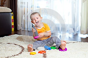 Funny child playing with color toy