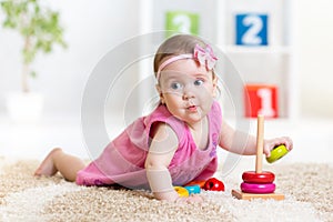 Funny child playing with color toy indoor