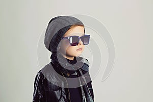 Funny child in scarf and hat.fashionable little boy in sunglasses