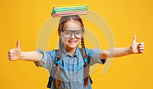 Funny child school girl girl on yellow background