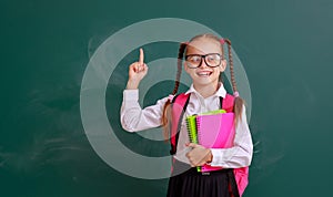 Funny child   schoolgirl girl student with book about school blackboard