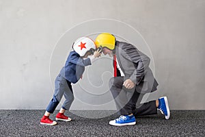 Funny child and senior man pretend to be businessmen