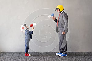 Funny child and senior man pretend to be businessmen