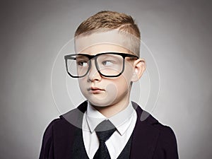 Funny child in suit and glasses