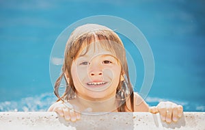 Funny child in swimming pool, close up face. Kids head portrait. Kids summer activities.