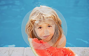 Funny child with watermelon. Kid having fun in swimming pool. Summer vacation and healthy eating.