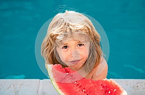 Funny child with watermelon. Kid having fun in swimming pool. Summer vacation and healthy eating.