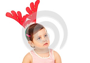 Funny child wearing christmas reindeer horns
