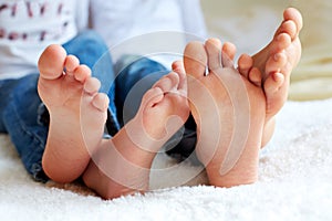 Funny children's foots is barefoot, closeup.