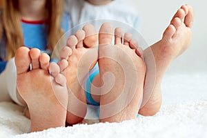 Funny children's foots is barefoot, closeup.