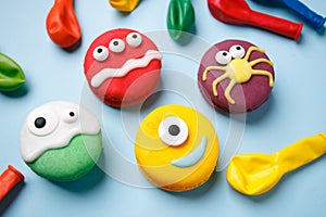 Funny children`s treats for Halloween: variations of macaroon, decorated in the form of different monsters, ghosts. Cooking proce