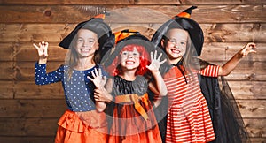 Funny children sister twins girl in witch costume in halloween