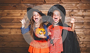 Funny children sister twins girl in witch costume in halloween