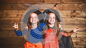 Funny children sister twins girl in witch costume in halloween