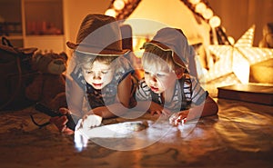 Funny children tourist with flashlight and world map and backp