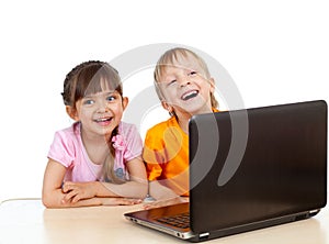 Funny children using a laptop