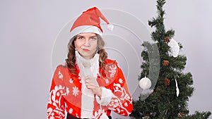 Funny Christmas girl with red fluffy Santa Hat and beard