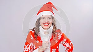 Funny Christmas girl with red fluffy Santa Hat and beard