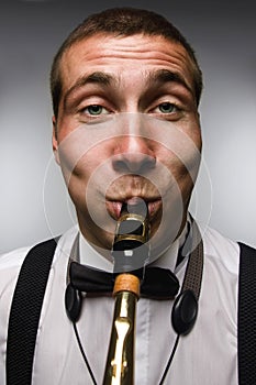 Funny closeup portrait of blowing saxophonist