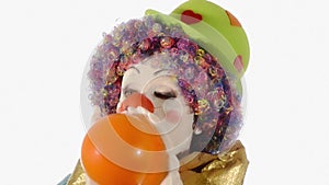 Funny clown blowing up a balloon