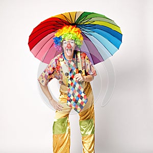 Funny clown with colorful umbrella